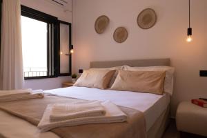 a bedroom with a bed with two towels on it at Tusa Bay in Castel di Tusa