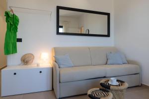 a living room with a couch and a mirror at Tusa Bay in Castel di Tusa
