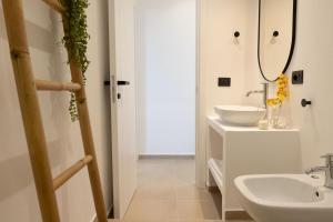 a bathroom with a sink and a mirror at Tusa Bay in Castel di Tusa