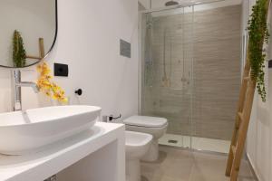 a bathroom with a sink and a toilet and a shower at Tusa Bay in Castel di Tusa