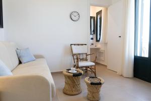 a living room with a couch and a chair at Tusa Bay in Castel di Tusa