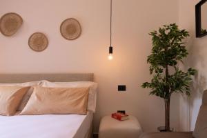 a bedroom with a bed and a potted plant at Tusa Bay in Castel di Tusa