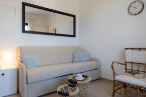 a living room with a couch and a mirror at Tusa Bay in Castel di Tusa