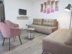 a living room with a couch and a table at Hegyköz Vendégház in Pusztafalu