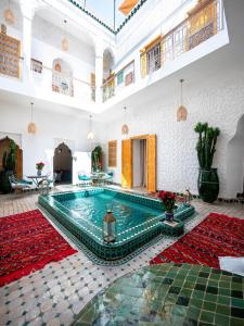 a large room with a pool in a building at Riad La Croix Berbere in Marrakesh