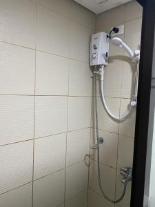 a shower in a bathroom with a shower head at Alitheia Condo @ Pine Suites Tagaytay in Tagaytay