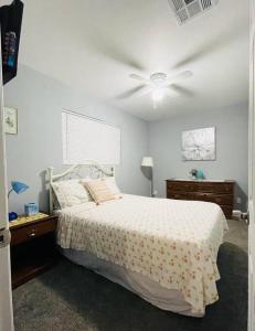 a bedroom with a bed and a ceiling fan at 2Bed/1Bath Fully Upgraded Suite in Glendale