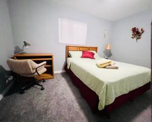 a bedroom with a bed and a desk and a chair at 2Bed/1Bath Fully Upgraded Suite in Glendale