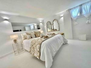 1 dormitorio blanco con 1 cama grande y paredes blancas en Mil y un momentos mágicos: Villa con encanto árabe en Marbella