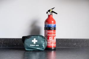 a bottle of first aid next to a fire extinguisher at Stunning Home Ideal for Business - Free Parking in Birstall