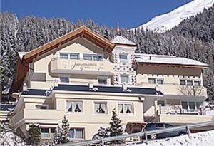 a large building on top of a snow covered mountain at Jungmann Apartments in Ischgl