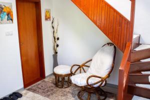 a room with a chair and a staircase at VillaH Weekend House in Visoko