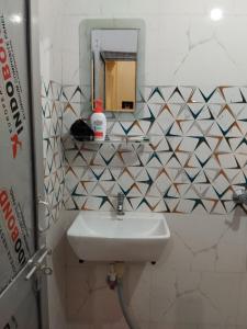 a bathroom with a sink and a mirror at Shubham guest house in Muzaffarpur