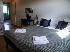 a bedroom with two beds with towels on a bed at Vassbo Logi & Event in Falun