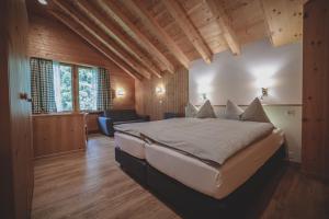 um quarto com uma cama grande num quarto em Hotel Garni Sonnenhalde em Arosa