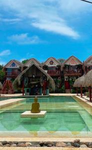 a swimming pool in front of a resort at hotel palmares beach in Palomino