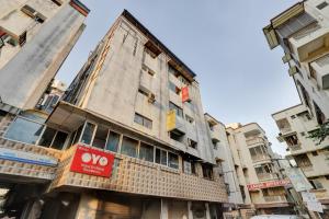 a building with a sign on the side of it at Hotel O Rudra Palace in Ahmedabad