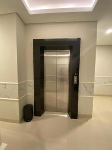 a hallway with a elevator in a building at Ghurfati Hotel Wedana in Jakarta