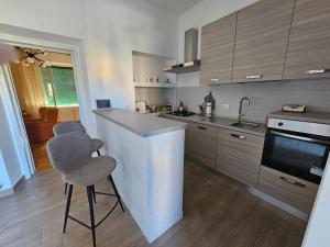 a kitchen with a counter and two bar stools at Casa Mafalda in Spoleto