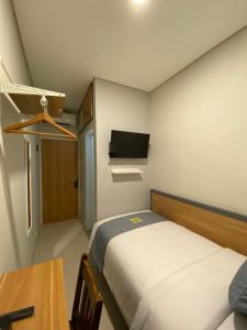Postel nebo postele na pokoji v ubytování Ghurfati Hotel Wedana