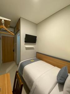 TV a/nebo společenská místnost v ubytování Ghurfati Hotel Wedana