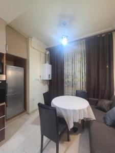 ein Wohnzimmer mit einem weißen Tisch und Stühlen in der Unterkunft Best Apartment In The City Center in Yerevan
