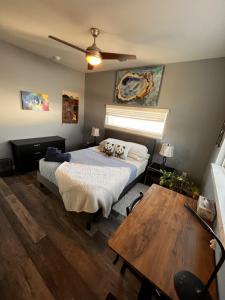 a bedroom with a bed and a table in it at Primary House East Austin Get Away in Austin