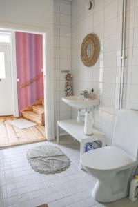 a bathroom with a toilet and a sink at Lakeside Guesthouse in Ramvik