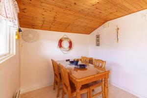 a dining room with a wooden table and chairs at Femöre Marina in Oxelösund