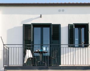a balcony with a table and two windows at Tusa Bay in Castel di Tusa