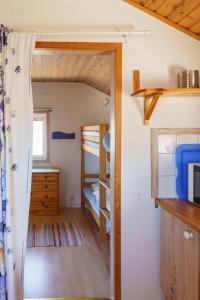 a small room with a bunk bed and a bedroom at Femöre Marina in Oxelösund