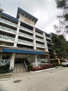 a large building with a clock on top of it at Alitheia Condo @ Pine Suites Tagaytay in Tagaytay