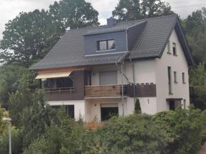 a white house with a black roof at Wohlfühloase in Sankt Wendel