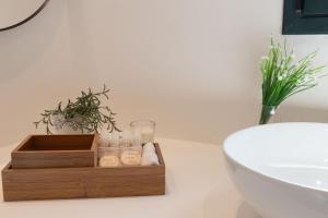 a bathroom with a wooden box of towels and a toilet at Tusa Bay in Castel di Tusa