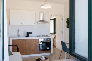 a kitchen with a sink and a stove top oven at Tusa Bay in Castel di Tusa