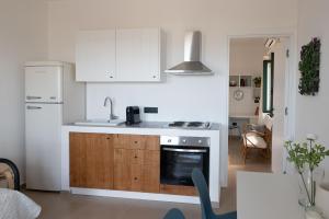 a kitchen with a sink and a stove top oven at Tusa Bay in Castel di Tusa