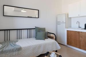 a small bedroom with a bed and a kitchen at Tusa Bay in Castel di Tusa