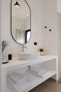 a bathroom with a sink and a mirror at Tusa Bay in Castel di Tusa