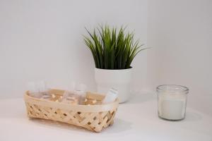 a basket of soap and a glass of milk and a plant at Tusa Bay in Castel di Tusa