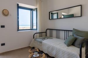 a bedroom with a bed and a mirror at Tusa Bay in Castel di Tusa