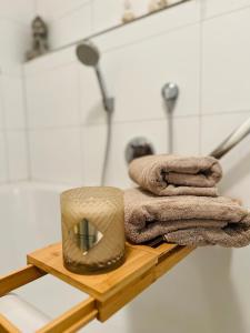 a wooden shelf with towels and a hat on it at Rosengarten Apartments in Tettnang in Tettnang