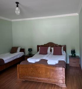 a bedroom with a wooden bed in a room at Guest House Tirebi in Nak'alak'evi