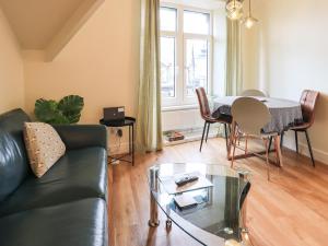 a living room with a black couch and a table at Windermere Crescent in Windermere