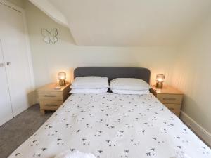 a bedroom with a large bed with two night stands at Windermere Crescent in Windermere