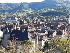 a town with houses and mountains in the background at Chez Claire in Latouille-Lentillac