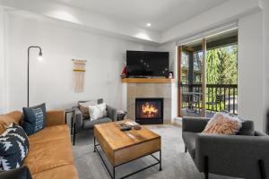 a living room with a couch and a fireplace at Stoney Creek Northstar by Whistler Premier in Whistler