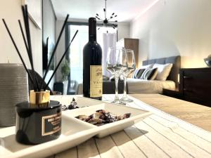 a table with a plate of food and a wine glass at Panama apartment in Ulcinj