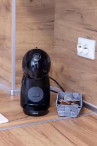 a blender sitting on a counter next to an outlet at Perfect Spot Apartment in Varna City