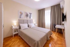 a hotel room with a large bed and a desk at Perfect Spot Apartment in Varna City