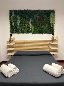 a bedroom with a bed with two towels on it at Tropical house in Lecce